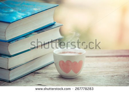 stock-photo-cup-of-tea-with-book-on-the-table-267778283.jpg