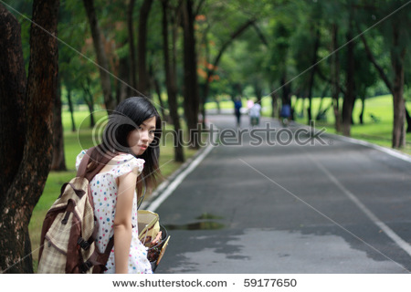 stock-photo-young-female-with-backpack-ride-bike-in-the-park-59177650.jpg