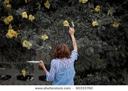 stock-photo-girl-with-paintbrush-painting-yellow-flower-on-background-60333760.jpg
